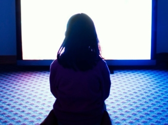 child watching glowing tv