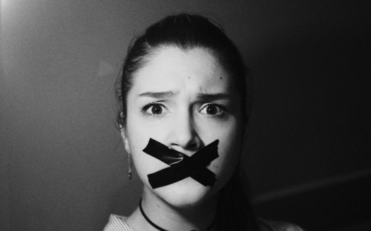 woman with mouth taped shut